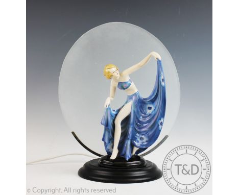 An Art Deco style table lamp, modelled with a Fasold & Stauch figure of a bather (restored) on an ebonised plinth set with a 