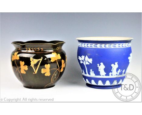 An Irish pottery jardiniere, titled 'Cead Mile Failte', decorated with the Celtic harp and shamrocks, inscribed 'Hibernia' to