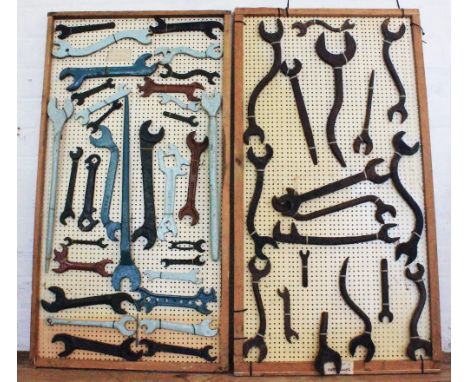 A collection of cast iron imperial spanners and tools, on two peg boards (Qty)