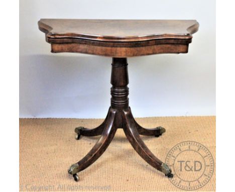 A Victorian walnut serpentine card table, with turned column and splayed legs, 75cm H x 92cm W