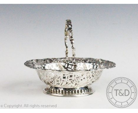 A Victorian silver bonbon dish Charles Stuart Harris, London 1889, of swing-handled oval form, with pierced detailing and whe