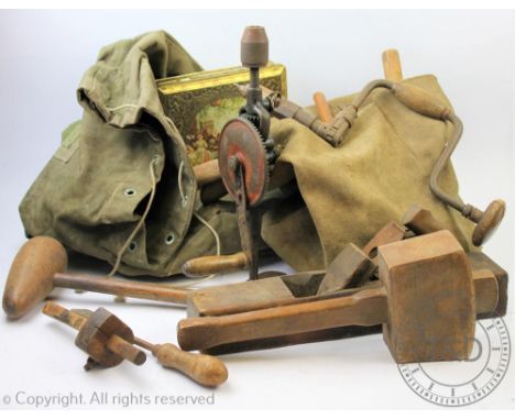A collection of assorted joinery and carpenters tools to include five hand drills, mallets, working planes, brass door handle