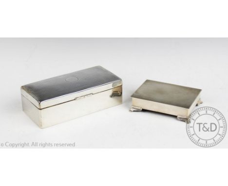 A silver box Harman Brothers, Birmingham 1954, of rectangular form, the hinged cover with engine turned detail and upon four 