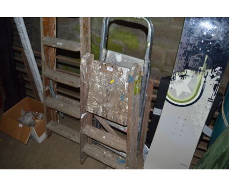 An aluminium step ladder together with a wooden step ladder