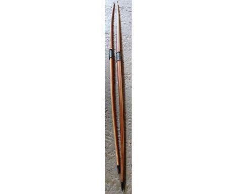 2 Yew wood longbows marked Eaton along with 2 leather arrow quivers &amp; arrows