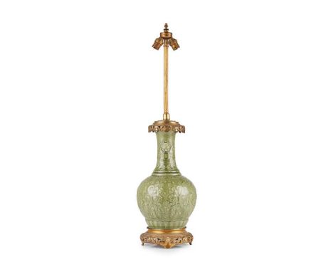 CELADON 'LOTUS' HANDLED VASE QING DYNASTY, 19TH CENTURY 清 青釉刻花卉紋雙獅耳瓶 the globular body topped with a stepped-base neck and te