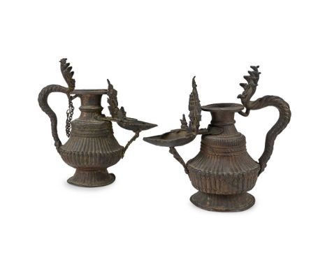 TWO NEPALESE SUKUNDAS  18TH-19TH CENTURY 十八至十九世紀 尼泊爾祭壇油燈（一對） each ritual oil lamp on circular spreading bases rising to flute