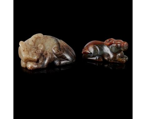 TWO JADE ANIMAL CARVINGS QING DYNASTY, 19TH CENTURY  清 青玉提油雕甪端擺件 及 青玉帶皮雕臥牛擺件（共兩件） comprising: a celadon and black jade carvin