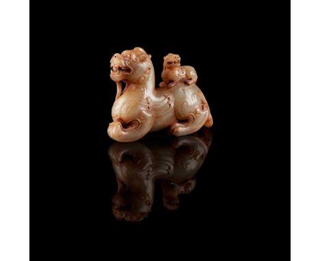 CELADON JADE CARVING OF MYTHICAL BEAST AND CUB 青玉仿古雕辟邪擺件 of Han style, carved with a Bixie prowling with the left front leg s