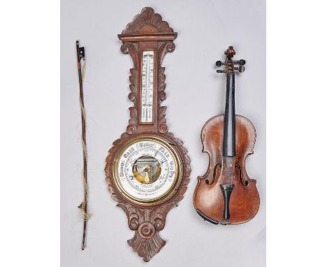 An Edwardian carved oak aneroid barometer, with mercury thermometer, 88cm h and a violin and bow (3) Bow broken. The other it