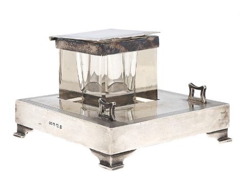 A George V square silver mounted glass inkwell and silver stand, engine turned borders, 10 x 10cm, by Deakin &amp; Francis Lt