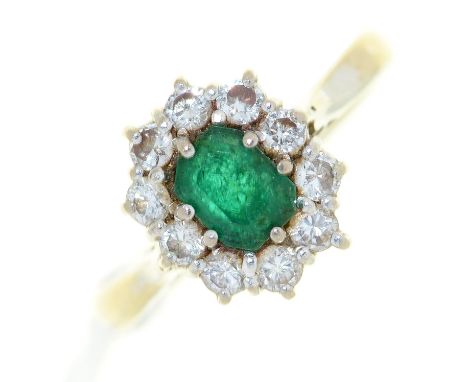 An emerald and diamond cluster ring, in 18ct white gold, London 1965, 5.9g, size K½ Good condition