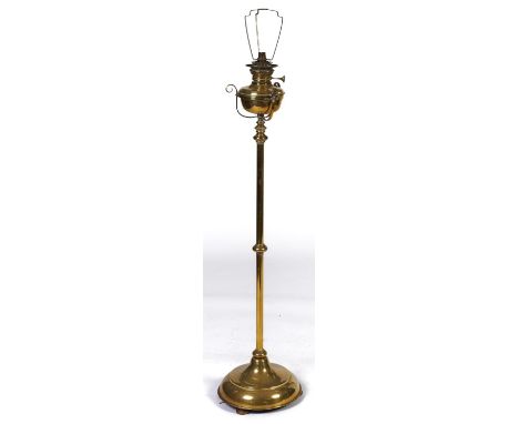 A Victorian brass telescopic oil lamp, with scroll mounted reservoir and burner, on knopped cylindrical column and spreading 