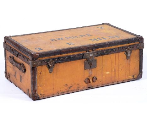 Luggage. A Louis Vuitton trunk, early 20th c, covered in orange Vuittonite canvas trimmed in stitched leather with brass nail