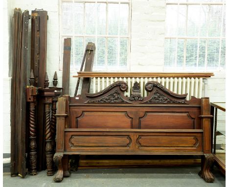 A carved and stained walnut half tester bed, with panelled head and footboard and leafy swan neck pediment, posts with spire 