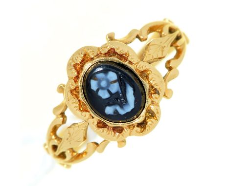 A hardstone cameo mourning ring, carved with an oval flower, pierced and engraved gold setting and fluted hoop, engraved Jane