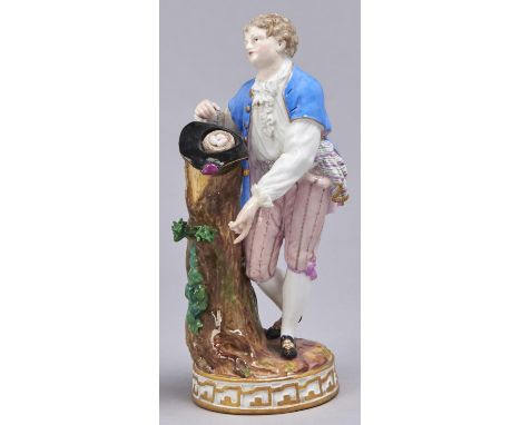 A Meissen figure of a youth with a bird's nest, late 19th c, on round gilt base, 18.5cm h, incised F68, crossed swords Some p