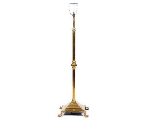 An Edwardian telescopic brass oil lamp standard, on square base and paw feet, converted to electricity, lacks fitment, telesc