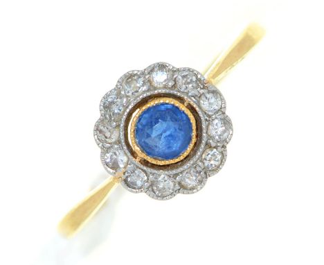 A sapphire and diamond cluster ring, millegrain set. in gold, unmarked, 2.7g,m size O 