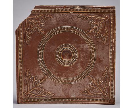 An English saltglazed brown stoneware wall tile, Nottingham, c1750, with central concavity within concentric rouletted ring a