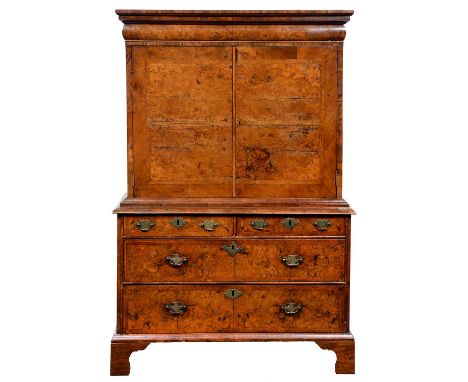 A Queen Anne walnut and feather banded cabinet on chest, c1710, the upper part with stepped cornice and cushion moulded drawe