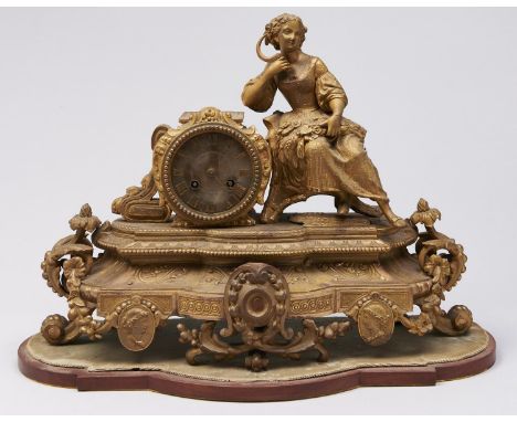 A French giltmetal mantel clock, 19th c, with drum cased bell striking movement, the swept case set with the seated figure of