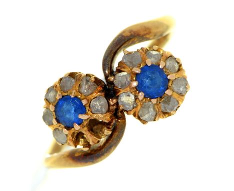 An Edwardian diamond and synthetic sapphire twin cluster ring, in gold, 2.3g, size H½ Several stones deficient; hoop bent