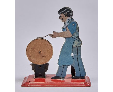 A&nbsp; mechanical lithographed tinplate figural knife grinder toy, c mid 20th c Slight wear to paint, working order