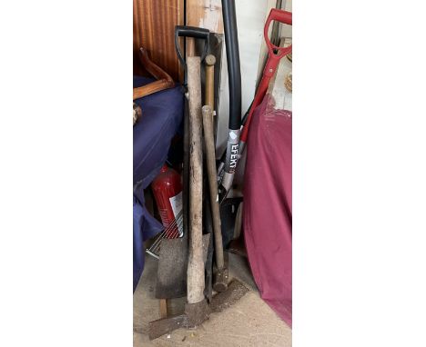 A sledgehammer together with a collection of gardening tools