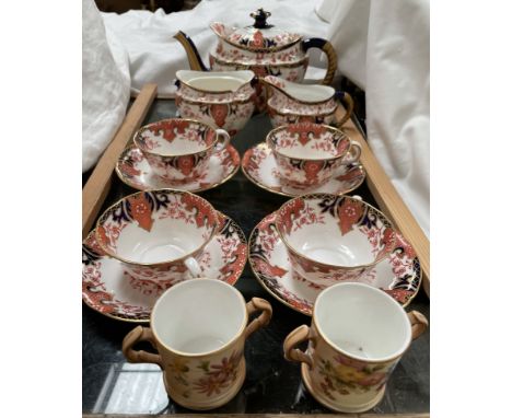 A Royal Crown Derby part tea set, comprising a teapot, cream jug, sugar basin and four cups and saucers, together with two Ro