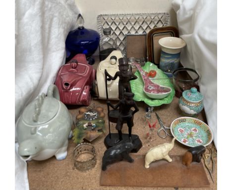 Novelty teapots in the form of racing cars together with carved African figures, hip flask, photograph frame etc