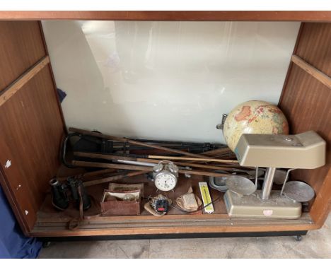 Assorted golf clubs together with a scales, globe, binoculars etc