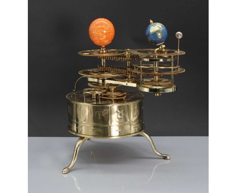 A brass planetarium,modern, plotting the Earth's orbit around the sun, the engine casing raised on cabriole legs, engraved to