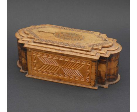 A Boer War prisoner-of-war folk art money box,1901, of casket form with a stepped lid, the sides and lid with chip carved det