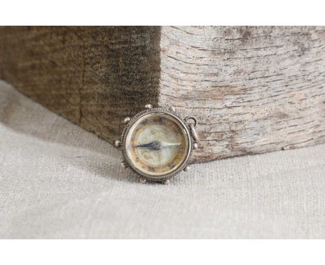 Early cycling interest: an unusual silver watch-fob-suspended compass,late 19th century, to the reverse with an enamelled mot
