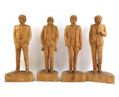 ▴ Simon O'Rourke (contemporary),'The Beatles', 2017, a group of four life-sized chainsaw-carved wood sculptures, each depicti