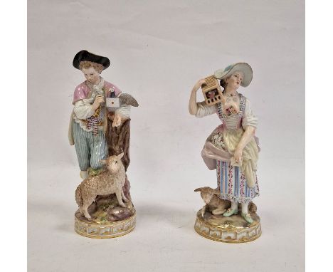 Pair Meissen figures, the lady holding letter, bird in cage on her shoulder and lamb at her feet, wearing bonnet with pink, b