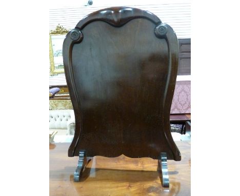 Late 19th century mahogany firescreen with carved decoration and shaped body, 80cm x 58cm 