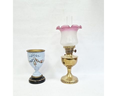 Victorian oil lamp with pink and white variegated shade and brass body and a glass-mounted and painted trophy-shaped vessel o