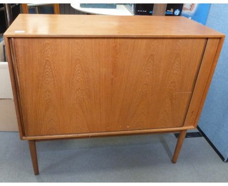 Mid century modern teak cabinet, the rectangular top above tambour door, on cylindrical tapering supports, 80.5cm high x 91.5