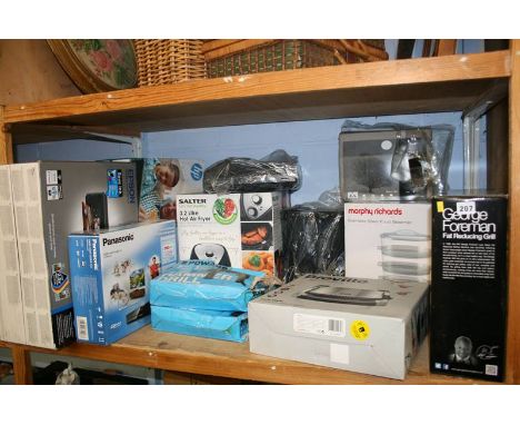 A shelf of boxed miscellaneous, George Foreman grill etc.