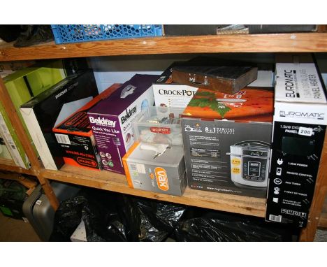 A shelf of boxed miscellaneous, digital glass panel heater etc.