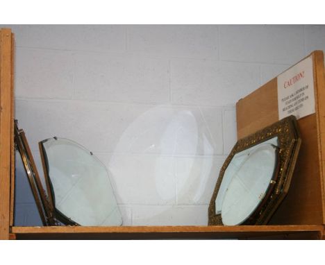 A shelf of framed and frameless hanging mirrors