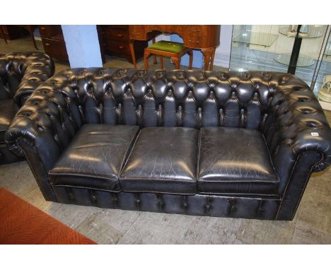 A blue leather three seater Chesterfield sofa and club chair