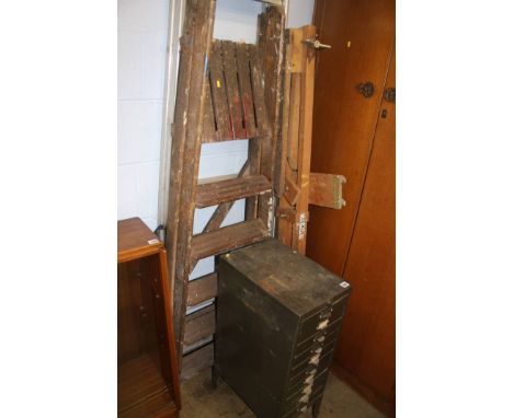 Step ladders, metal filing cabinet and an artists easel