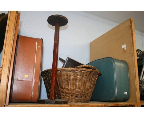 A shelf of miscellaneous;  suitcase, wicker basket etc.