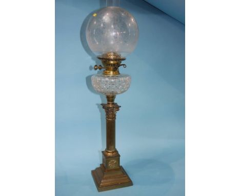 A Victorian oil lamp with etched clear glass shade and facet cut reservoir. 74cm height