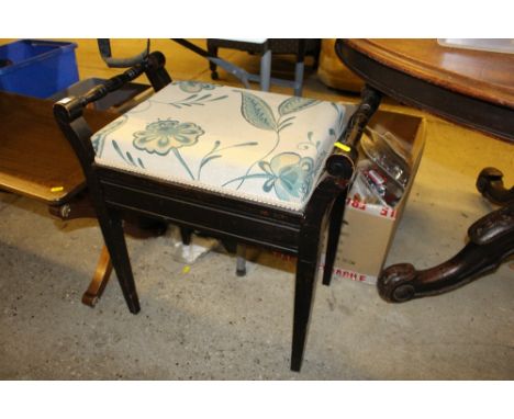 An Edwardian mahogany piano stool with lift-up top 