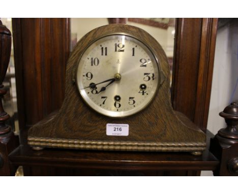 A 20th Century oak three hole mantel clock 