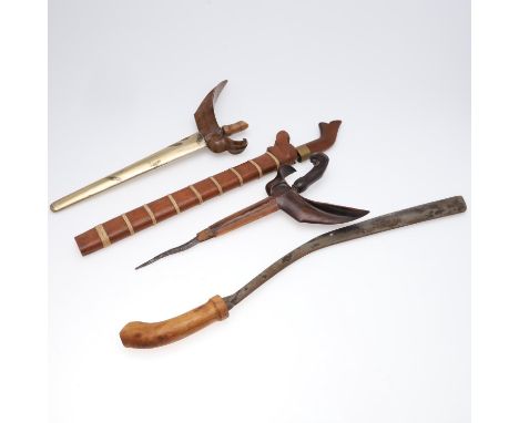 A Kris type dagger with a 33cm in an oversized scabbard with elaborate scrolling cross bar and brass wrapped body, 47cm x 21c